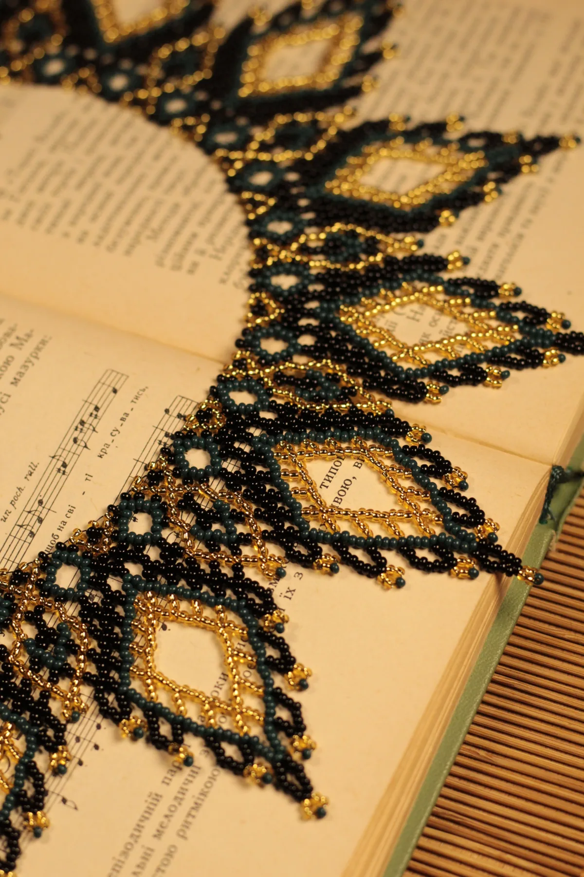 Black, teal and gold sylianka netting on an open songbook