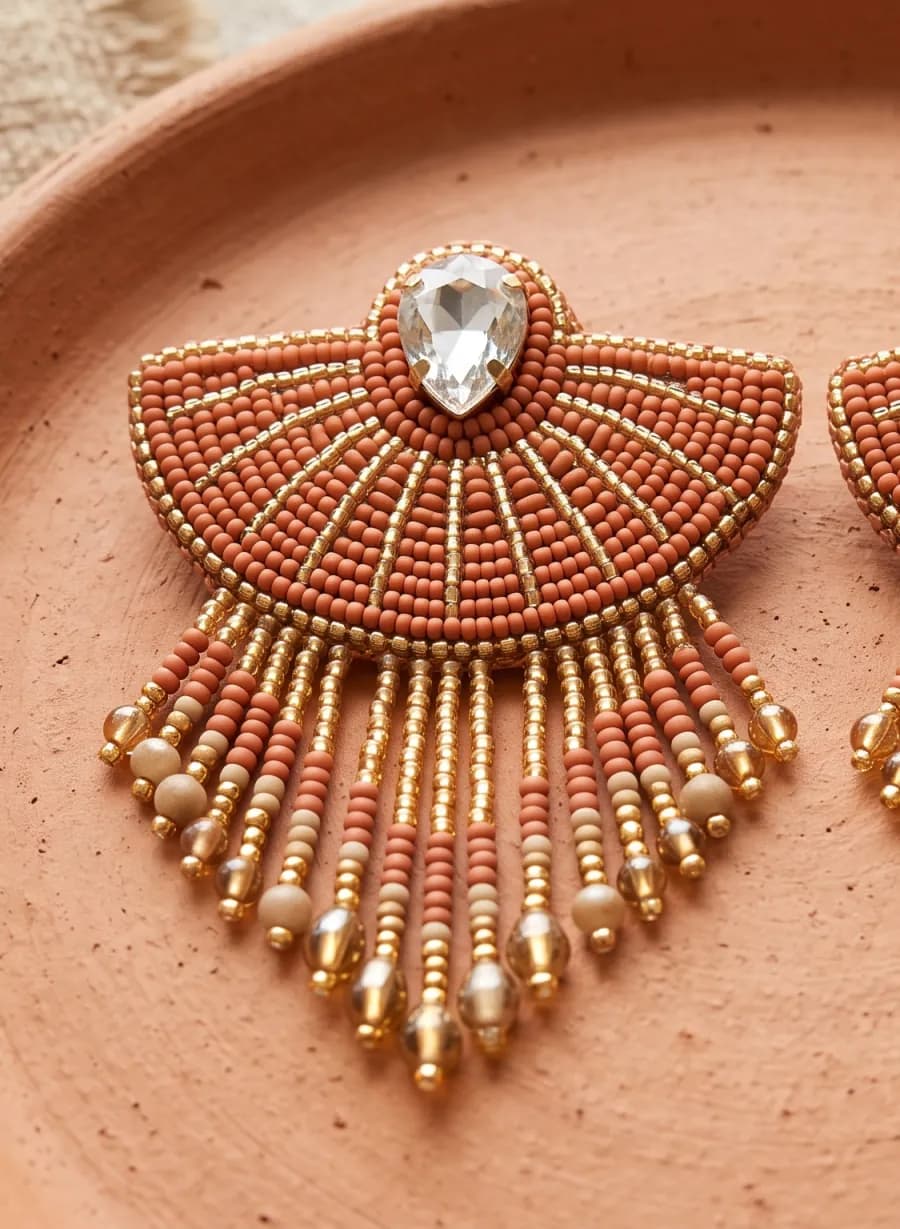 Bead-embroidered fan earring in terracotta and gold with a crystal and fringe