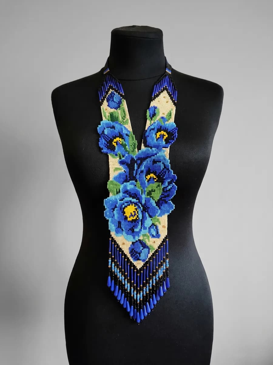Gerdan with large blue flowers and long fringe on a black mannequin